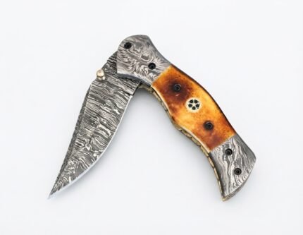 Damascus Folding Pocket Knife with silver-gray patterned blade, amber-brown handle, decorative metal bolsters and thumb stud