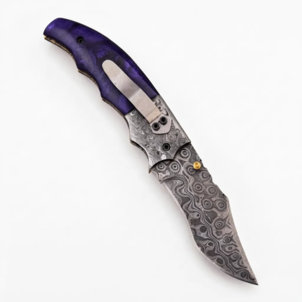Purple handle Damascus folding knife with silver-gray circular mosaic-style blade patterns, contoured violet grip and metal pocket clip