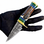 Antler-Look Damascus Pattern Hunting Knife with silver-gray patterned blade, brown textured handle, blue-green spacers, gold-colored guard and brown stitched sheath.