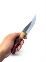 Red and Black Wood Handle Fixed Blade Hunting Knife with polished and dark two-tone blade beside a brown basketweave-style sheath