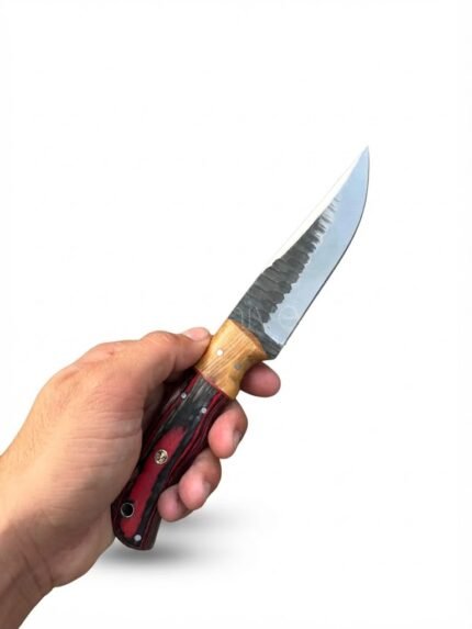Red and Black Wood Handle Fixed Blade Hunting Knife with polished and dark two-tone blade beside a brown basketweave-style sheath