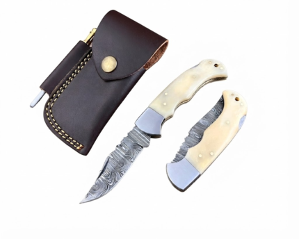 Damascus pattern folding pocket knife opened to show its curved silver-grey blade and red-and-cream geometric handle, displayed beside a dark brown stitched pouch and slim accessory.