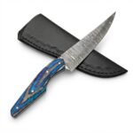 Blue handle trailing point knife with a gray patterned blade, four silver-tone pins, and a curved blue-and-gray grip resting across a black stitched sheath.