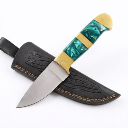 Turquoise marbled handle knife displayed diagonally across a black embossed sheath with decorative interlacing pattern.
