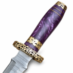 Purple Handle Damascus Pattern Dagger with a long silver patterned blade, ornate gold-tone crossguard, marbled violet grip and brown stitched sheath