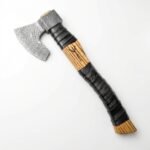 Damascus Pattern Bearded Hatchet with silver-grey curved axe head, striped brown wood-look handle, black wrapped grip and V-shaped handle marking