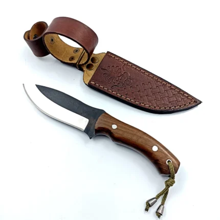 Wood Handle Hunting Knife with curved black and silver blade, brown wood-grain handle, two metal pins and olive-green cord lanyard