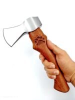 Mini camping hatchet with a polished silver-colored single-bit axe head, curved brown woodgrain-style handle and engraved paw-print design