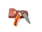 Amber Handle Damascus Knife with a silver-gray patterned blade, amber-and-cream handle, and brown stitched leather-look sheath featuring a gold-colored snap.