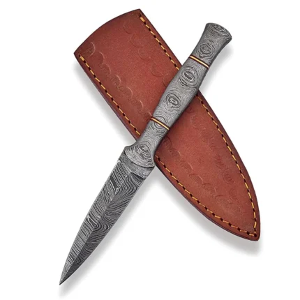 Patterned handle knife with a slim pointed blade, grey-and-silver Damascus-style markings and two red-and-gold-tone handle bands