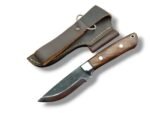Rustic fixed blade knife with a dark textured blade, brown grain-pattern handle, two silver-tone pins, and bright bolster over a brown stitched sheath.