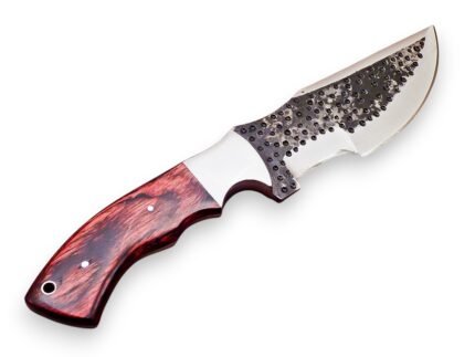 Hammered finish hunting knife with broad curved silver blade, dark circular dimples and red-black wood-grain handle