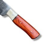 Reddish brown handle Damascus hunting knife featuring a silver-gray patterned fixed blade, cream front handle accent and brown stitched sheath