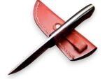 Rasp texture fixed blade knife with a black-and-brown handle, silver-tone pins, and a rear eyelet, displayed over a stitched reddish-brown sheath.