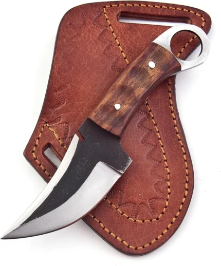 Wood Handle Ring Pommel Skinner Knife with a broad curved black and silver blade, brown wood-grain handle and reddish-brown stitched belt-style sheath.