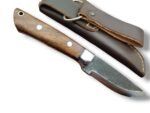 Rustic fixed blade knife with a dark textured blade, brown grain-pattern handle, two silver-tone pins, and bright bolster over a brown stitched sheath.