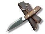 Rustic fixed blade knife with a dark textured blade, brown grain-pattern handle, two silver-tone pins, and bright bolster over a brown stitched sheath.