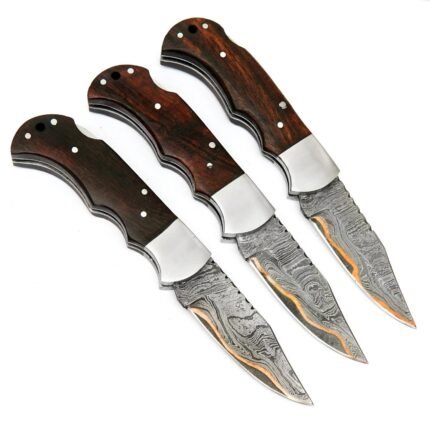 Damascus Pattern Skinner Knife with curved silver-gray blade, brown wood-grain handle, finger grooves and decorative fittings beside an inch-marked ruler.