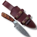 Damascus Pattern Skinning Knife with wavy silver-grey blade, reddish-brown figured handle, polished bolster and burgundy-brown dual-strap sheath.